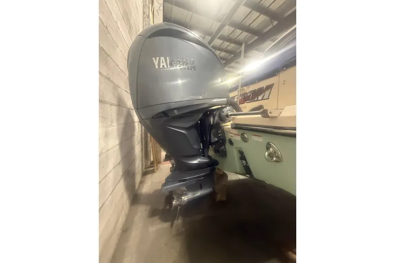 Slide: The Image of 2022 Grady-White Freedom 307 boat with Yamaha outboard motor in a garage. - 31
