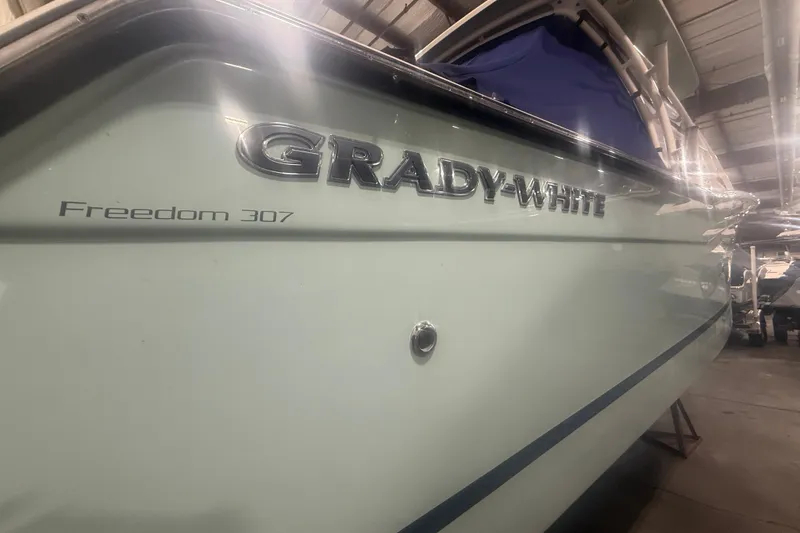Slide: The Image of 2022 Grady-White Freedom 307 boat in a showroom, side view. - 33