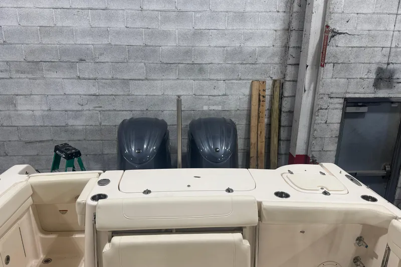 Slide: The Image of 2022 Grady-White Freedom 307 boat with dual engines in a garage setting. - 6