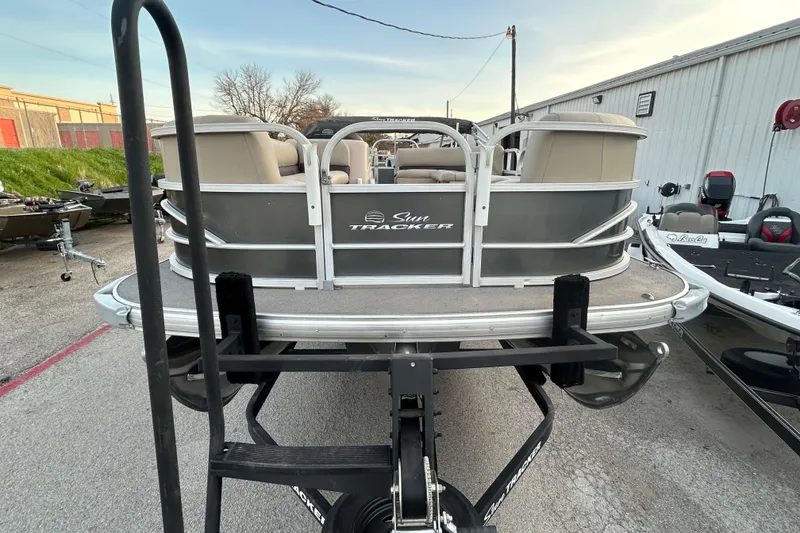 Slide: The Image of 2017 Sun Tracker Party Barge 24 DLX pontoon boat on trailer by the water. - 2