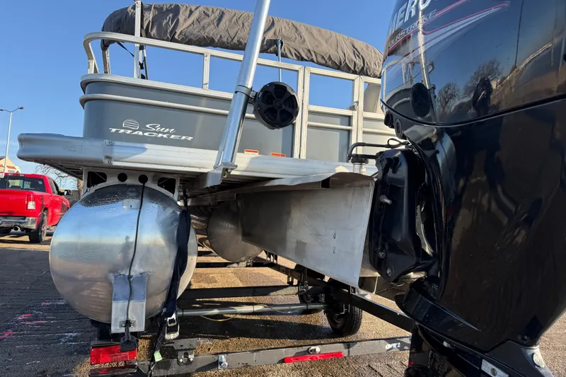 Slide: The Image of 2017 Sun Tracker Party Barge 24 DLX pontoon boat with outboard motor, rear view. - 24