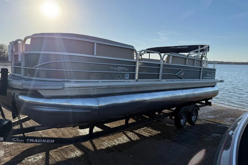Slide: The Image of 2017 Sun Tracker Party Barge 24 DLX pontoon boat on trailer by a lake. - 28