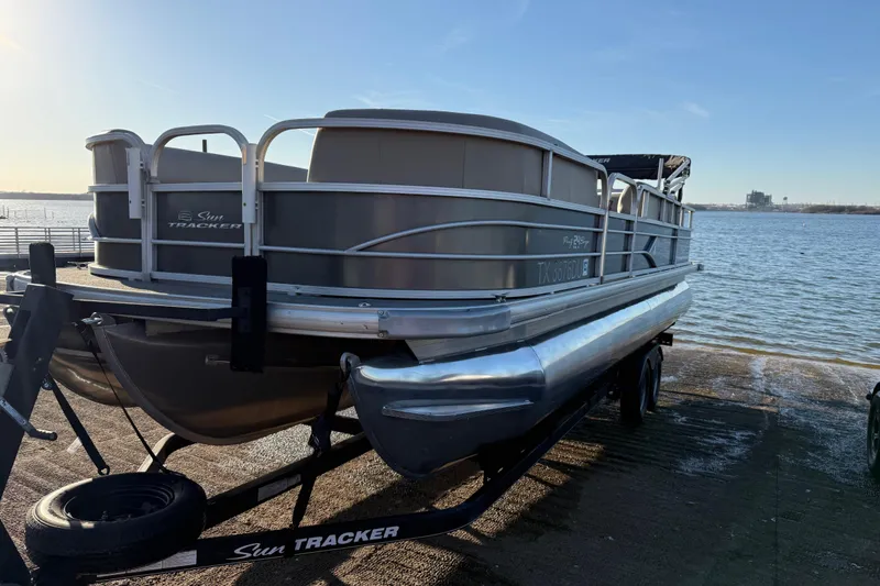 Slide: The Image of 2017 Sun Tracker Party Barge 24 DLX pontoon boat on trailer by the water. - 30