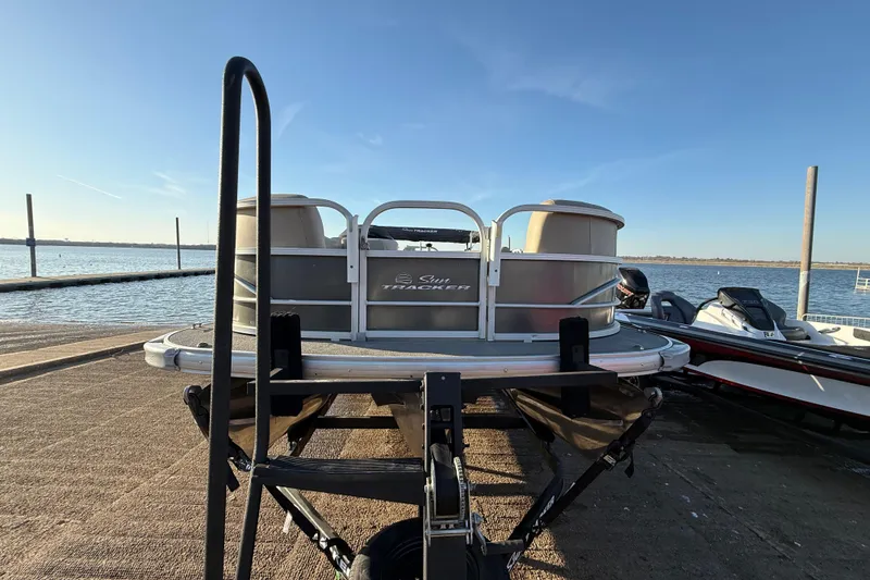 Slide: The Image of 2017 Sun Tracker Party Barge 24 DLX pontoon boat on trailer by the water. - 32