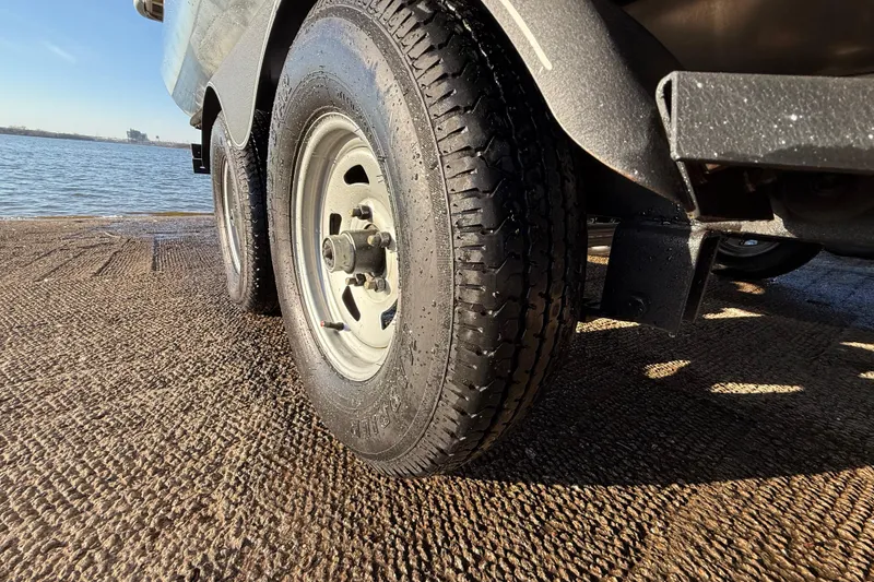 Slide: The Image of Trailer tire of 2017 Sun Tracker Party Barge 24 DLX near water. - 34