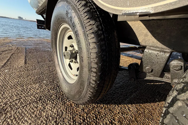 Slide: The Image of Trailer tire of 2017 Sun Tracker Party Barge 24 DLX near water. - 35