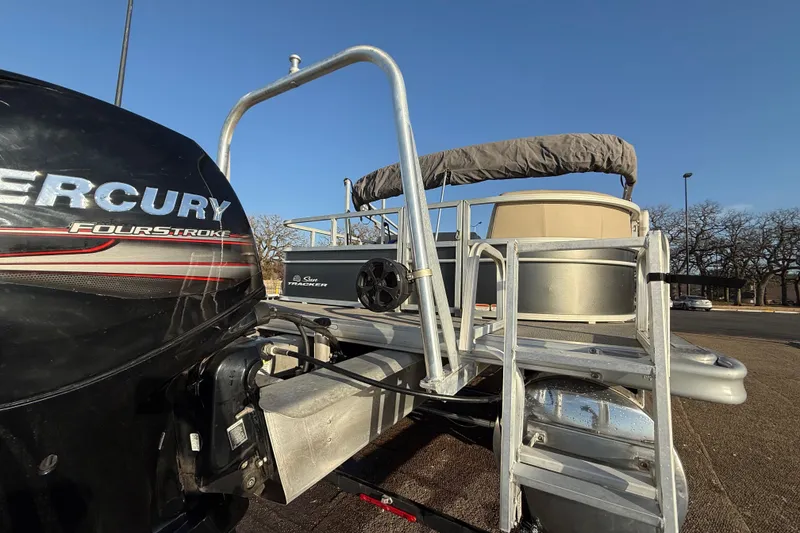 Slide: The Image of 2017 Sun Tracker Party Barge 24 DLX with Mercury FourStroke engine, parked outdoors. - 36