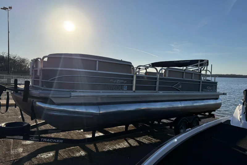Slide: The Image of 2017 Sun Tracker Party Barge 24 DLX pontoon boat on trailer by a lake. - 39