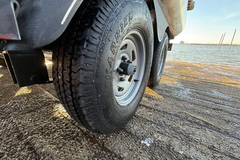 Slide: The Image of Trailer tire of 2017 Sun Tracker Party Barge 24 DLX near water. - 41