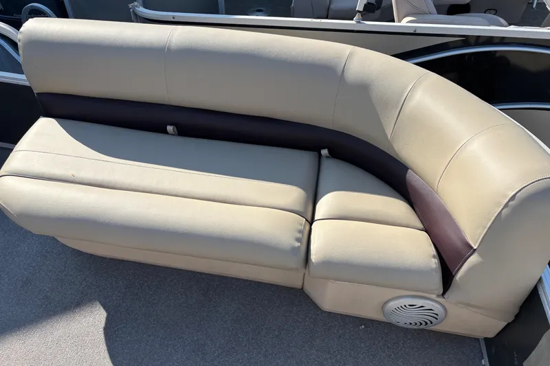 Slide: The Image of 2017 Sun Tracker Party Barge 24 DLX beige seating with integrated speaker. - 49