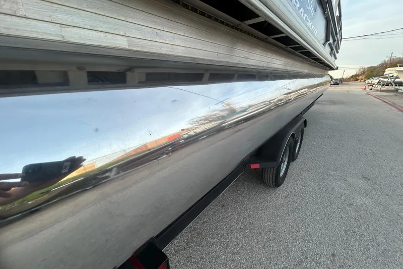 Slide: The Image of 2017 Sun Tracker Party Barge 24 DLX XP3 capacity label: 12 persons or 1685 lbs, 150 HP motor. - 5