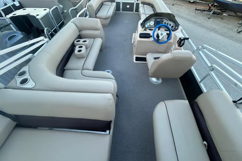 Slide: The Image of 2017 Sun Tracker Party Barge 24 DLX interior with beige seating and steering console. - 52