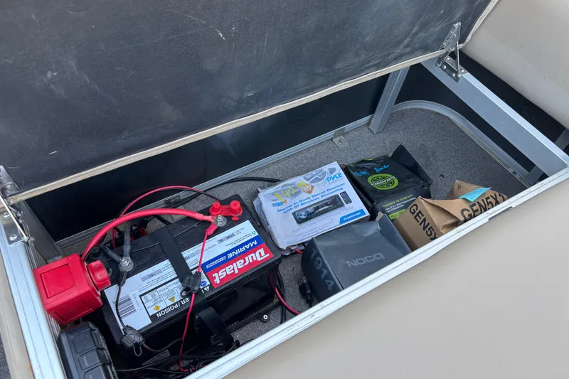 Slide: The Image of Storage compartment of a 2017 Sun Tracker Party Barge 24 DLX with marine battery and accessories. - 54