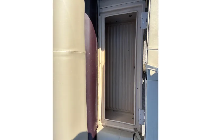 Slide: The Image of 2017 Sun Tracker Party Barge 24 DLX storage compartment with beige and maroon upholstery. - 59