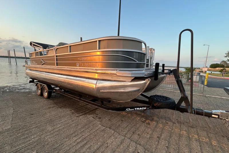Slide: The Image of 2017 Sun Tracker Party Barge 24 DLX pontoon boat on trailer at lakeside. - 68