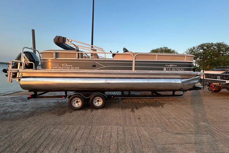 Slide: The Image of 2017 Sun Tracker Party Barge 24 DLX pontoon boat on trailer at lakeside. - 69