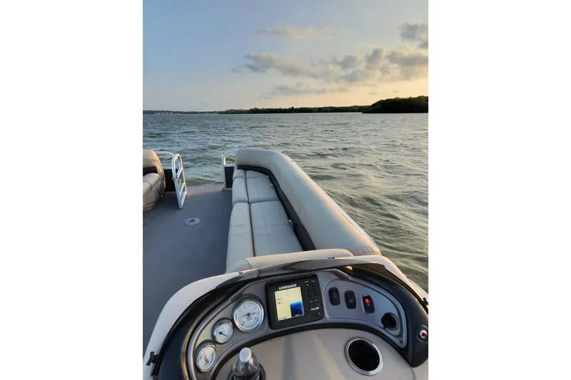 Slide: The Image of 2017 Sun Tracker Party Barge 24 DLX on a serene lake at sunset. - 73