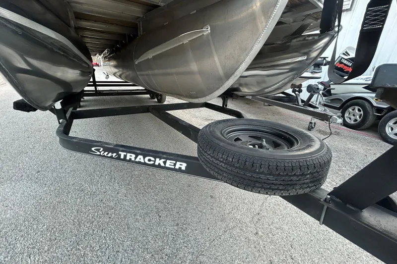 Slide: The Image of 2017 Sun Tracker Party Barge 24 DLX pontoon boat on trailer by the water. - 9