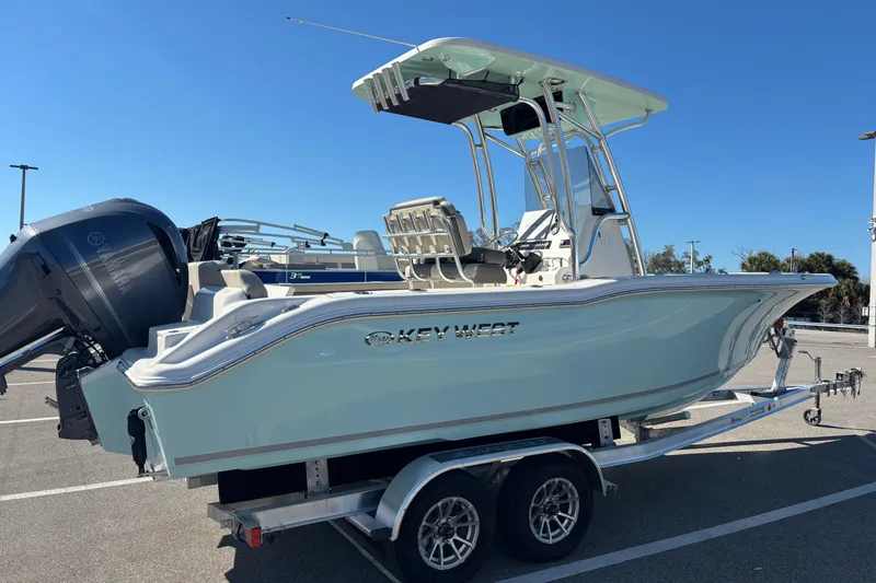 Slide: The Image of 2025 Key West 239 FS boat on trailer, parked in sunny lot. - 1
