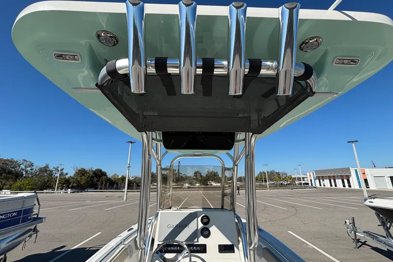 Slide: The Image of 2025 Key West 239 FS boat with T-top and rod holders in a parking lot. - 10