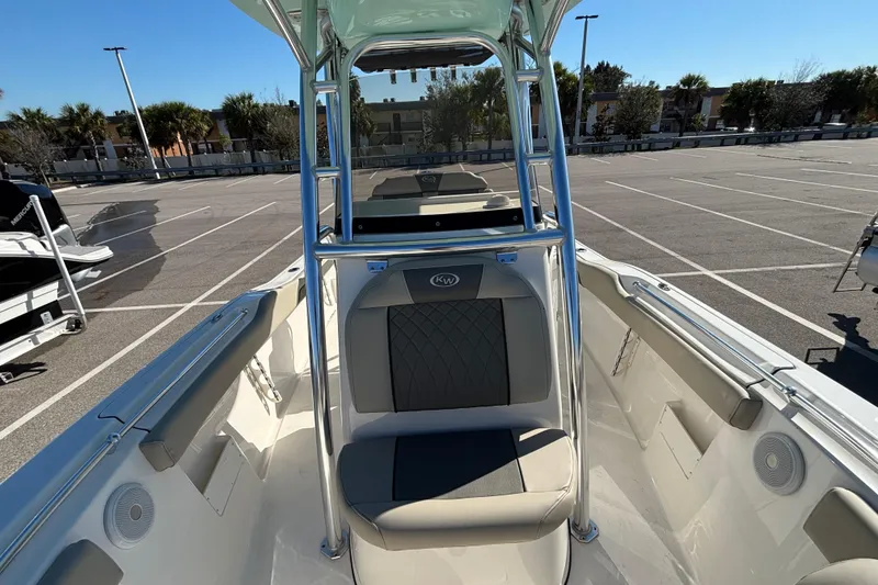 Slide: The Image of 2025 Key West 239 FS boat interior with seating, parked in a sunny lot. - 14