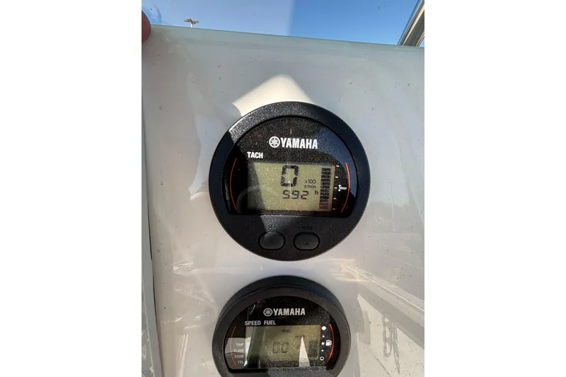 Slide: The Image of Yamaha tachometer and speed fuel gauges on 2025 Key West 239 FS boat dashboard. - 16