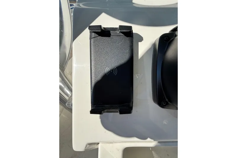 Slide: The Image of Wireless charging pad on 2025 Key West 239 FS boat console. - 19