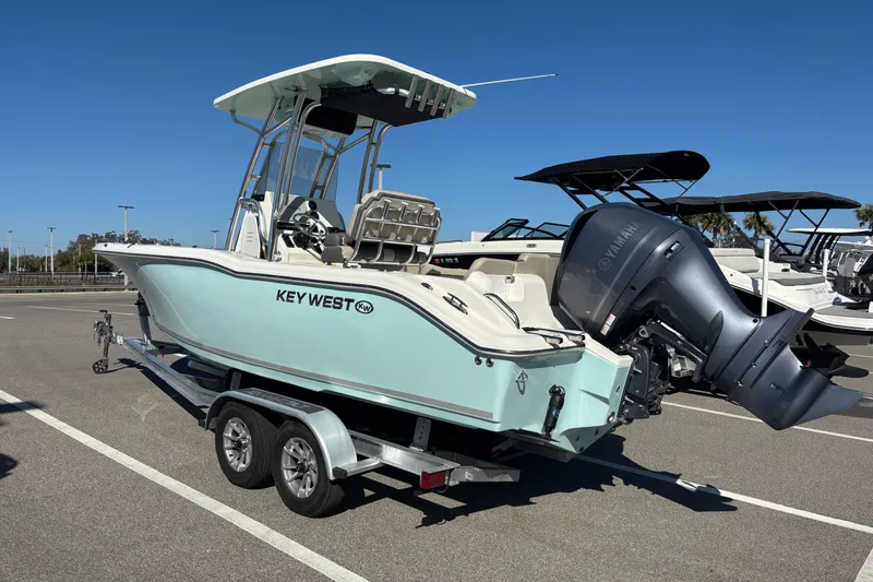 Slide: The Image of 2025 Key West 239 FS boat on trailer, featuring Yamaha outboard motor, parked in sunny lot. - 3