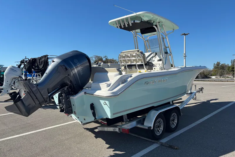 Slide: The Image of 2025 Key West 239 FS boat on trailer, featuring a powerful outboard motor. - 4