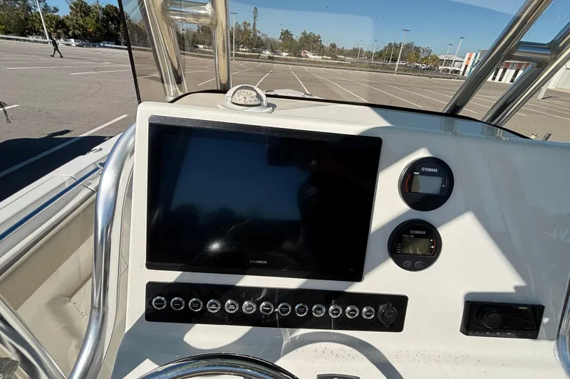 Slide: The Image of 2025 Key West 239 FS boat dashboard with Garmin display and Yamaha gauges. - 7