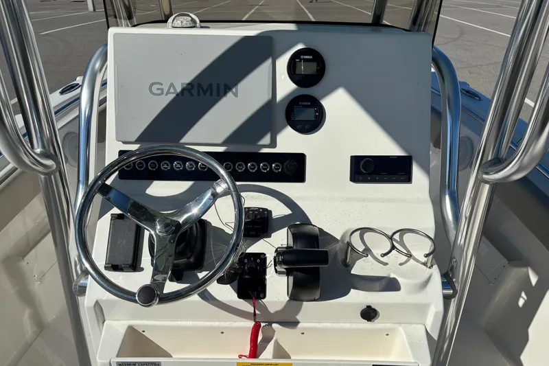 Slide: The Image of 2025 Key West 239 FS boat console with Garmin navigation and steering wheel. - 9