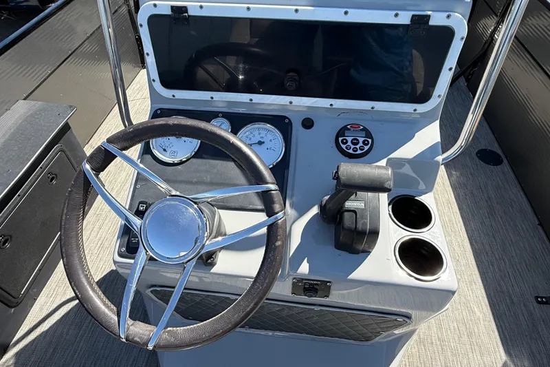 Slide: The Image of Steering console of 2018 Misty Harbor 210 RF boat with gauges and controls. - 33