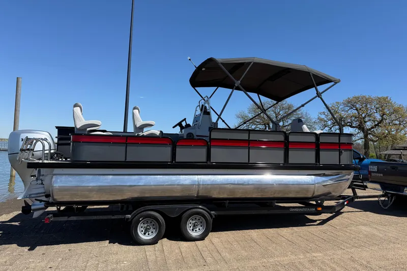 Slide: The Image of 2018 Misty Harbor 210 RF pontoon boat on trailer, under clear blue sky. - 42