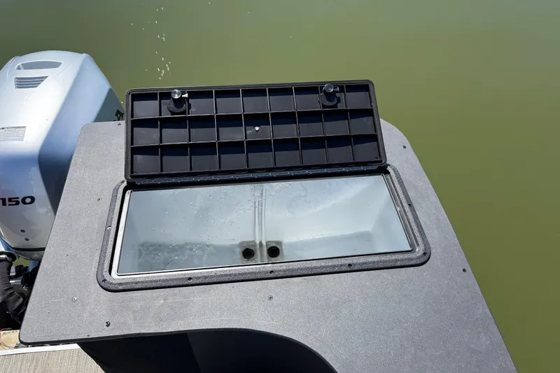 Slide: The Image of Open storage compartment on 2018 Misty Harbor 210 RF boat, near outboard motor. - 48