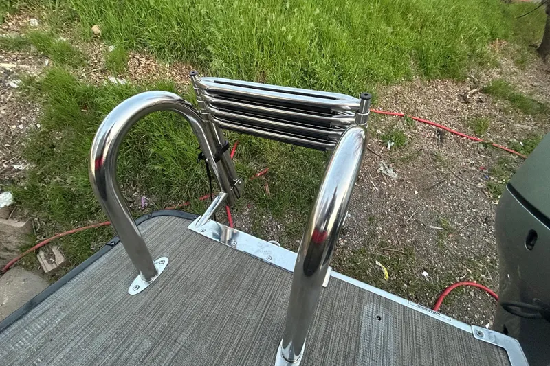 Slide: The Image of Stainless steel boat ladder on Misty Harbor 2285RF, 2018 model, with grassy background. - 13