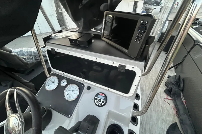 Slide: The Image of 2018 Misty Harbor 2285RF boat dashboard with gauges and navigation equipment. - 19