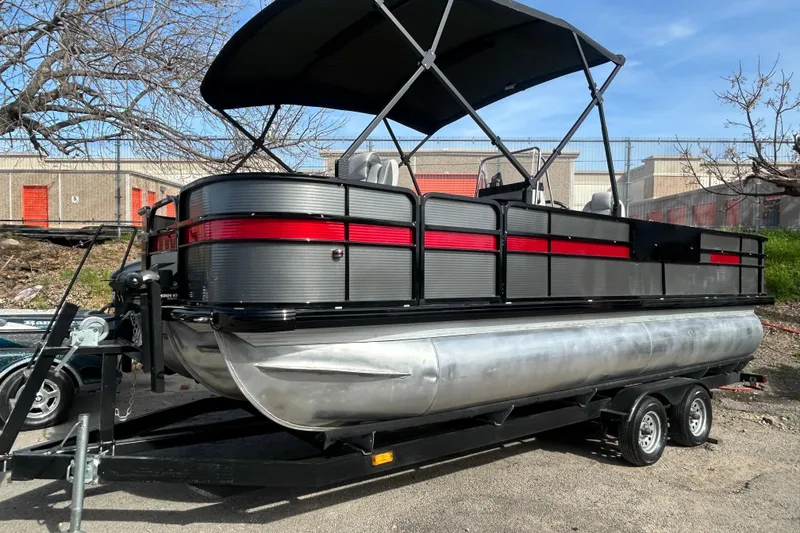 Slide: The Image of 2018 Misty Harbor 2285RF pontoon boat on trailer, featuring black and red accents. - 31