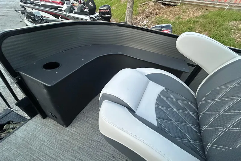 Slide: The Image of 2018 Misty Harbor 2285RF boat interior with gray seating and cup holder. - 9