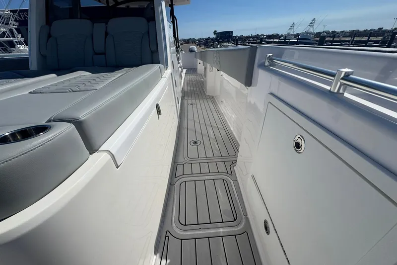 Slide: The Image of 2023 Twin Vee 400 GFX CC boat interior with sleek seating and modern deck design. - 14