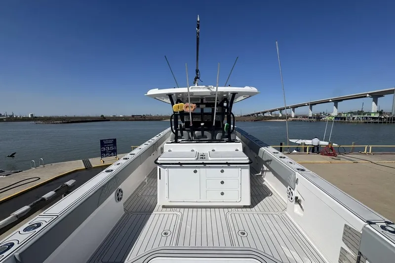 Slide: The Image of 2023 Twin Vee 400 GFX CC boat docked by a waterfront with clear blue skies. - 21