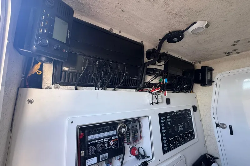 Slide: The Image of 2023 Twin Vee 400 GFX CC boat interior with electronic control panels and wiring. - 8
