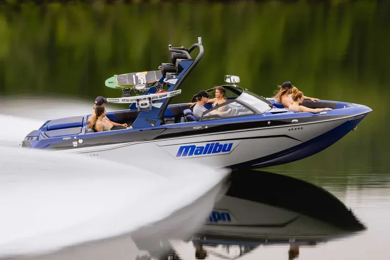 Slide: The Image of Manufacturer Provided Image: 2022 Malibu Wakesetter 23 LSV speedboat on a calm lake with passengers. - 0