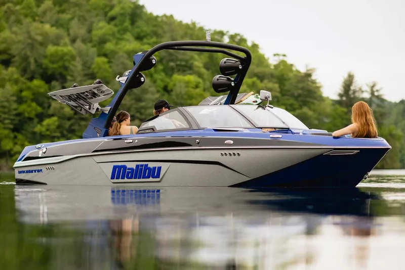 Slide: The Image of Manufacturer Provided Image: 2022 Malibu Wakesetter 23 LSV on a serene lake with lush green background. - 1