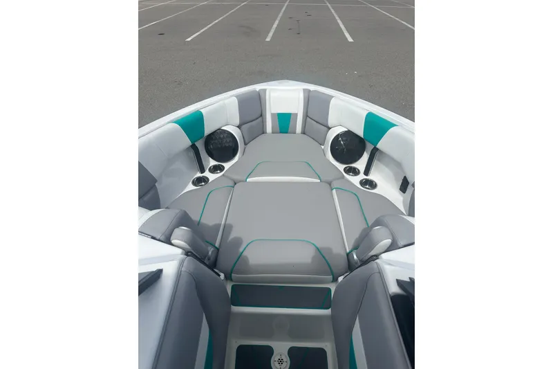 Slide: The Image of 2022 Malibu Wakesetter 23 LSV boat interior with gray and teal seating. - 12