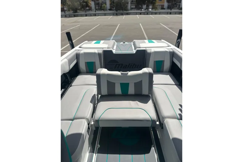 Slide: The Image of 2022 Malibu Wakesetter 23 LSV interior with gray and teal seating in a parking lot. - 14