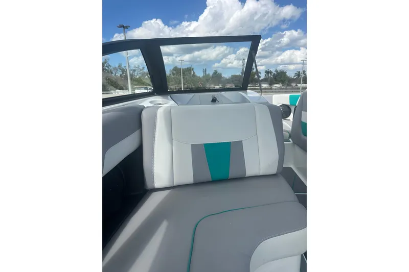Slide: The Image of 2022 Malibu Wakesetter 23 LSV interior with stylish seating under a blue sky. - 16