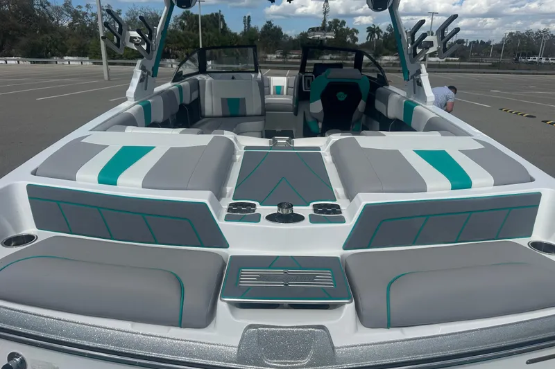 Slide: The Image of 2022 Malibu Wakesetter 23 LSV boat interior with gray and teal seating. - 17