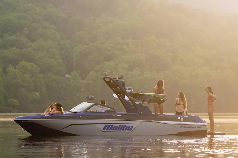 Slide: The Image of Manufacturer Provided Image: 2022 Malibu Wakesetter 23 LSV boat on a lake with people enjoying the water. - 2