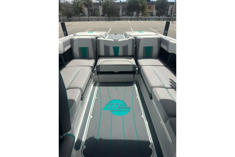 Slide: The Image of 2022 Malibu Wakesetter 23 LSV interior with gray and teal seating in a parking lot. - 9