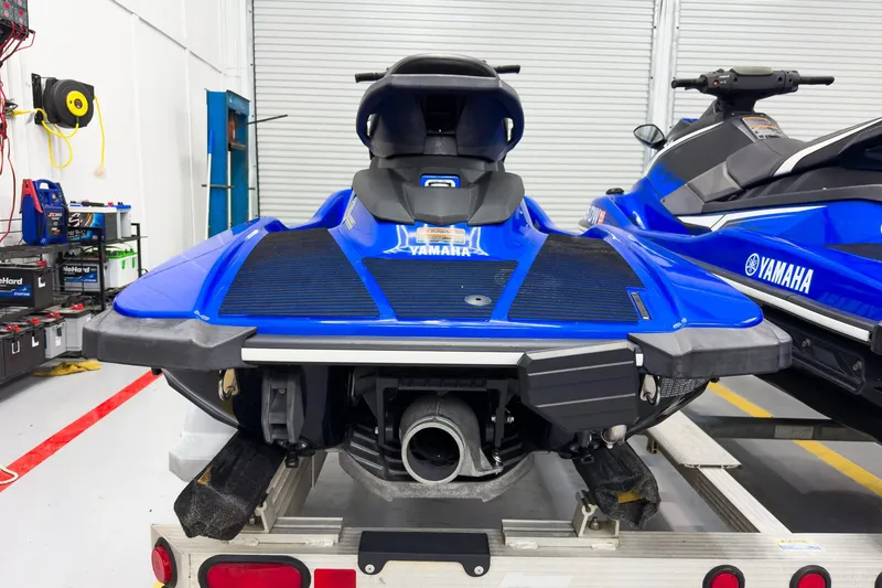 Slide: The Image of 2018 Yamaha WaveRunner EX Deluxe in a garage, rear view, blue color. - 11
